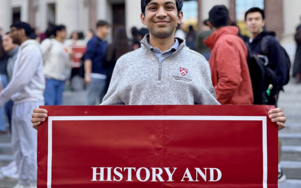 I pose with the sign for History and Science in front of Widener Library
