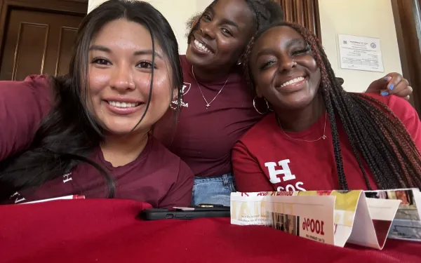 Three students smiling for a picture.