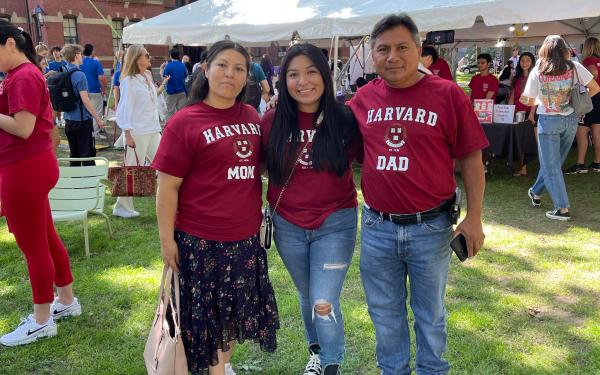 Three people smiling at the camera. 