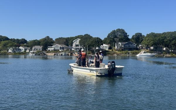 A researcher from Waquoit Bay National Estuarine Reserve taking students out on a research boat.
