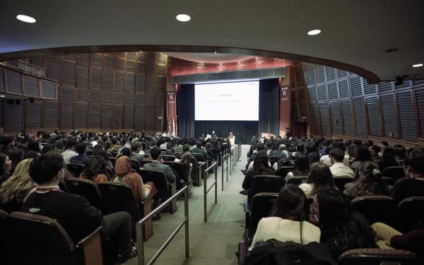 Large auditorium at the Arab Conference at Harvard 2025 with speakers and an audience.