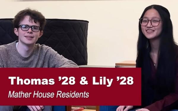 Two students sit side by side indoors under a large painting, with text labeling them as Mather House residents celebrating the Harvard Houses.