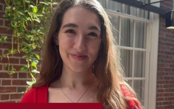Student in a red shirt smiles in a sunny brick courtyard, with text celebrating Leverett House.