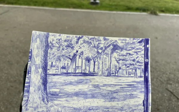 Sketch of a park environment in blue ink on a notepad. 