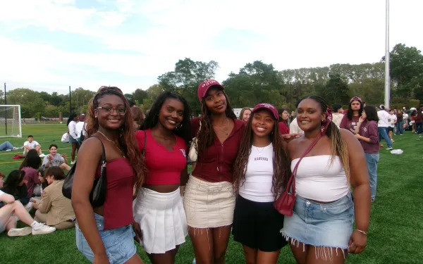 A picture of myself and my friends at the Harvard vs. Brown football game. Each person is wearing a variation of Harvard merchandise and crimson