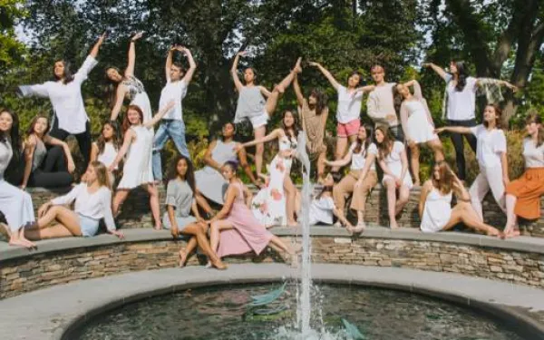 students dancing and posing on a bridge