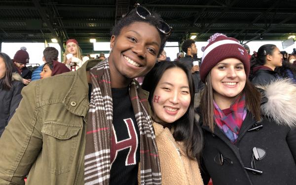three students at the 2018 Harvard Yale game