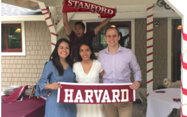 Students holding Harvard flag