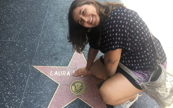 student sitting on the Hollywood Walk of Fame